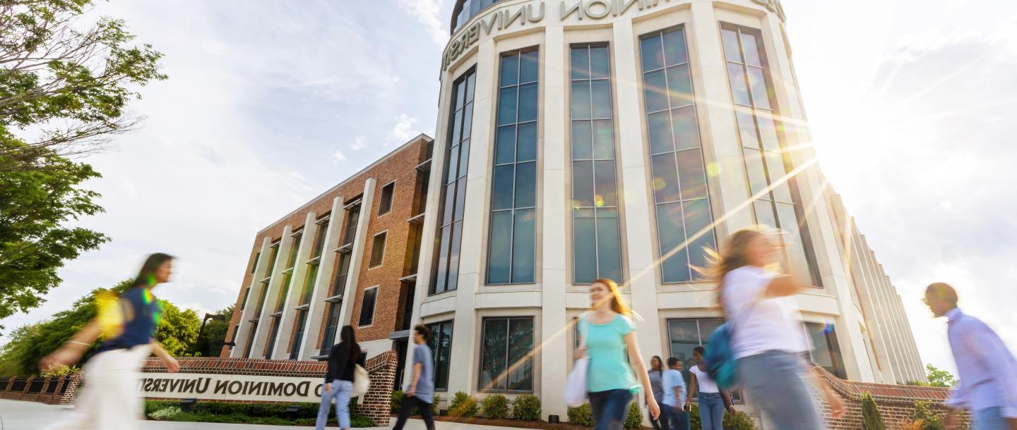 Group of students walking in front of the education building